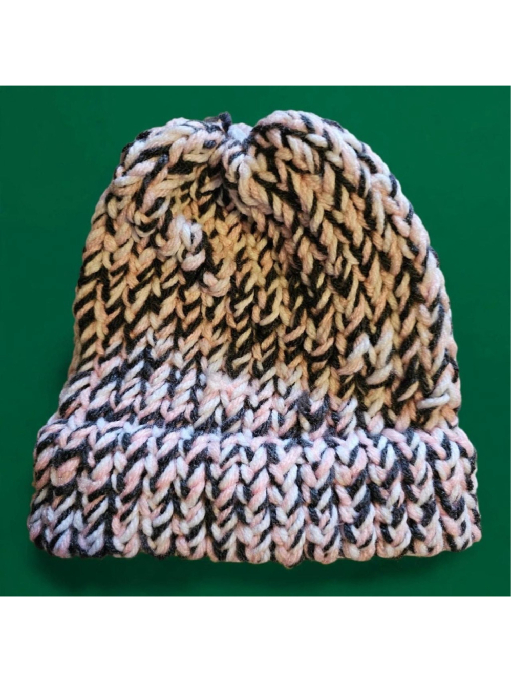 Handmade knit beanie with black, beige, and pink yarn #handmade #knitwear